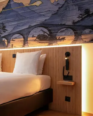 a bedroom with a bed with a painting on the wall at Comic Art Hotel in Ghent