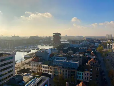 a view of a city with a river and buildings at London Tower Apartments - Antwerp in Antwerp