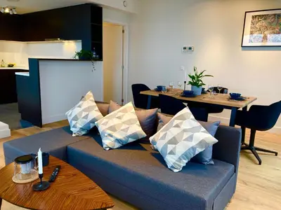 a living room with a couch and a table at London Tower Apartments - Antwerp in Antwerp