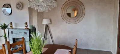 a dining room with a table and a mirror at SUPERB FLAT WITH 3 BEDROOMS PARKING AND BALCONy in Antwerp