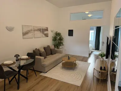 a living room with a couch and a table at Cozy South-Up and Ground in Brussels