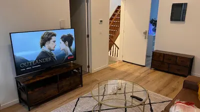 a living room with a flat screen tv at Cozy South-Up and Ground in Brussels