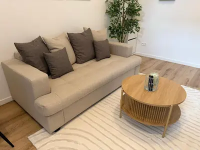 a living room with a couch and a coffee table at Cozy South-Up and Ground in Brussels