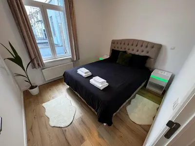 a small bedroom with a bed and a window at Cozy South-Up and Ground in Brussels