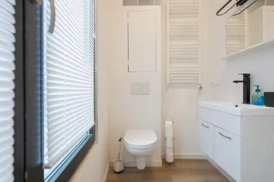 a bathroom with a toilet and a sink at Miniloft Pelgrim in Antwerp