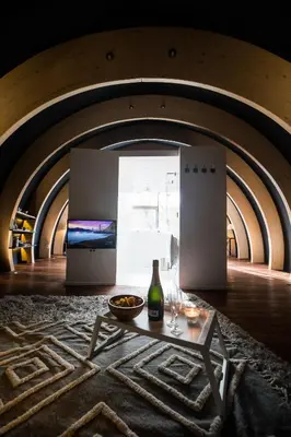 a room with a table and a bottle of wine at Room8 luxury glamping in Huldenberg