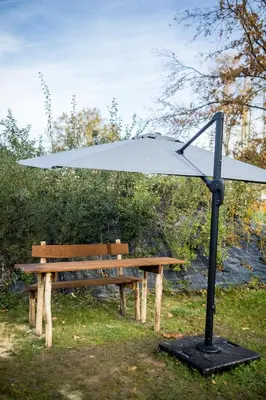 a white umbrella sitting on top of a park bench at Room8 luxury glamping in Huldenberg