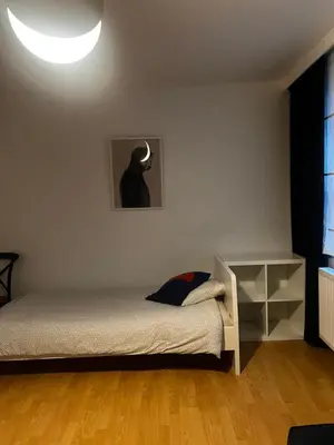 a bedroom with a bed and a lamp on the wall at Apartment 202 in Ghent
