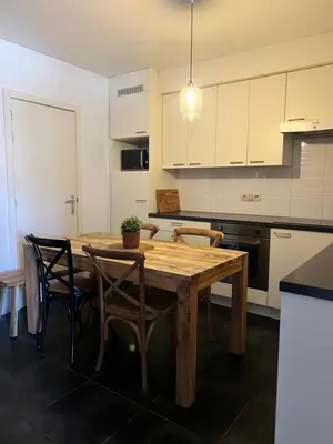 a kitchen with a wooden table and chairs at Apartment 202 in Ghent