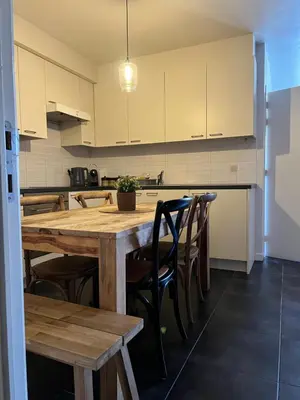 a kitchen with a large wooden table and chairs at Apartment 202 in Ghent