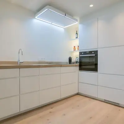 a kitchen with white cabinets and a sink at ANCHOR LODGE ANTWERP Unique Appartment view MAS! in Antwerp