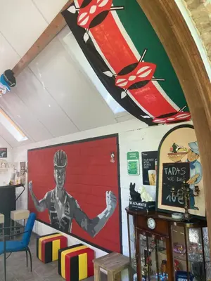 a wall with a painting of a man on skis at Karibu Keerbergen in Keerbergen