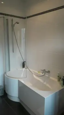 a white bathroom with a shower and a sink at charming house with 3 bedrooms & terrace 10 minutes from city centre in Antwerp