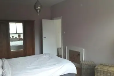 a bedroom with a white bed and a window at charming house with 3 bedrooms & terrace 10 minutes from city centre in Antwerp