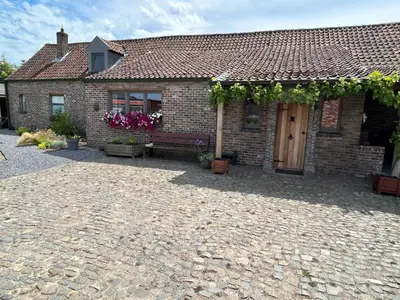 a brick house with a bench in front of it at CasaDeKaMa in Evergem
