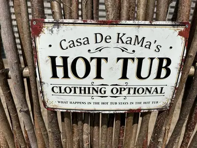 a sign on the side of a corrugated iron fence at CasaDeKaMa in Evergem