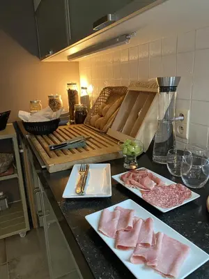 a kitchen with two plates of meat on a counter at CasaDeKaMa in Evergem