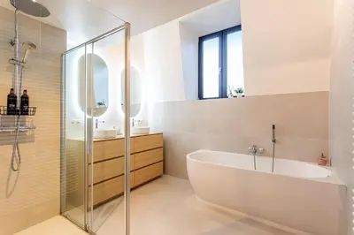 a bathroom with a tub and a glass shower at Loft Gent in Ghent