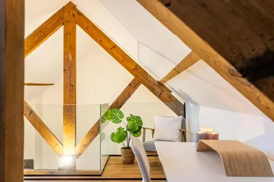 a dining room with a glass table and chairs at Loft Gent in Ghent