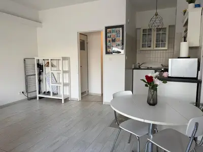a kitchen and dining room with a table and chairs at Lovely condo next to European Area in Brussels