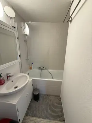 a bathroom with a sink and a bath tub at Lovely condo next to European Area in Brussels