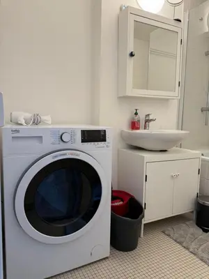 a washing machine in a bathroom with a sink at Lovely condo next to European Area in Brussels