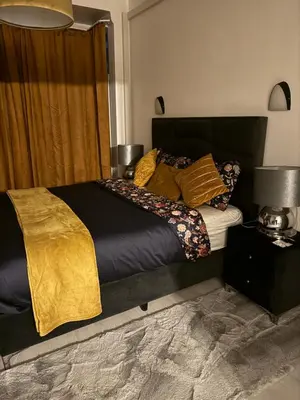a bedroom with a large bed with pillows on it at Appartement 2 chambre luxueuse à jette in Brussels