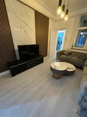 a living room with a couch and a coffee table at Appartement 2 chambre luxueuse à jette in Brussels