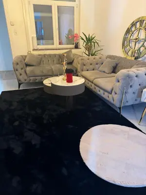 a living room with a couch and a table at Appartement 2 chambre luxueuse à jette in Brussels