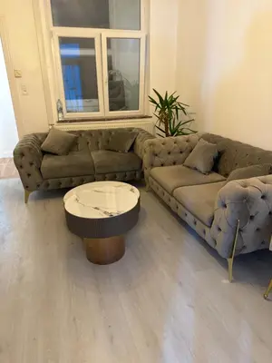 a living room with a couch and a coffee table at Appartement 2 chambre luxueuse à jette in Brussels
