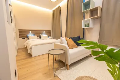 a bedroom with a bed and a couch and a table at Golden Dove Luxury Aparts in Brussels
