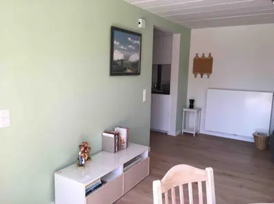 a living room with a white wall with a white board at 'het T-huisje' volledig ingerichte studio in Leuven
