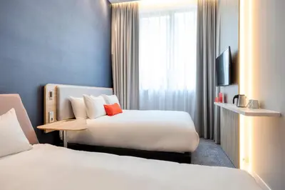 a hotel room with two beds and a television at Holiday Inn Express Antwerp - City Centre by IHG in Antwerp