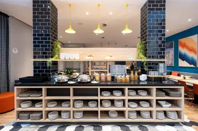a kitchen with a counter with dishes at Holiday Inn Express Antwerp - City Centre by IHG in Antwerp