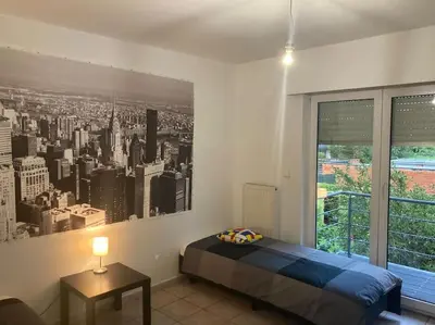 a bedroom with a large picture of a city at Superbe appartement lumineux et spacieux in Antwerp