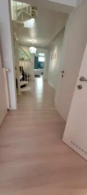 an empty hallway of an apartment with white walls and wood floors at Bruxelles ma belge in Brussels