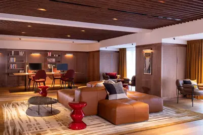 a living room with a couch and chairs and a table at L-Avenue in Brussels