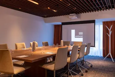 a conference room with a large wooden table and chairs at L-Avenue in Brussels