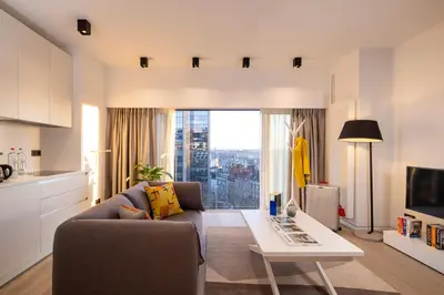 a living room with a couch and a table at L-Avenue in Brussels