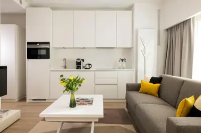 a living room with a couch and a table with yellow pillows at L-Avenue in Brussels
