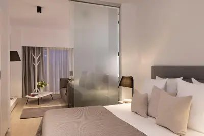 a bedroom with a bed and a living room at L-Avenue in Brussels