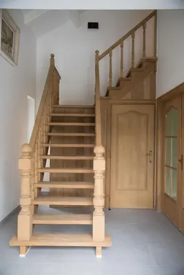 a wooden staircase in a room with a door at Vakantiewoning Den Appel in Dendermonde