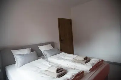 a bedroom with two beds with towels on them at Vakantiewoning Den Appel in Dendermonde