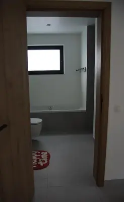 a bathroom with a toilet and a window at Vakantiewoning Den Appel in Dendermonde
