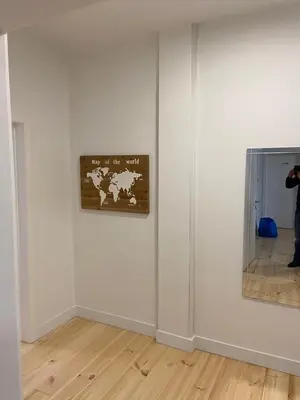 a person taking a picture of a wall in an art exhibit at Modern Apartment Third Floor in Brussels