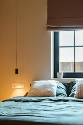a bed in a room with a window at 'De Zandrug' vakantiehoeve - B&B in Stekene