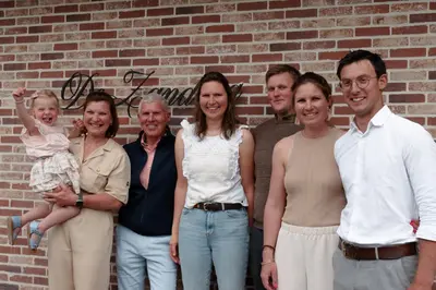 a group of people standing in front of a brick wall at 'De Zandrug' vakantiehoeve - B&B in Stekene