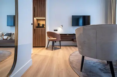 a living room with a desk and a chair at ONE TWO FOUR - Hotel & Spa in Ghent