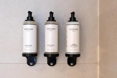 a group of three bottles on a wall at ONE TWO FOUR - Hotel & Spa in Ghent