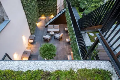 an overhead view of a patio with furniture and plants at ONE TWO FOUR - Hotel & Spa in Ghent